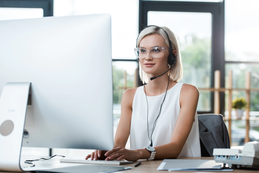 Receptionist with headset helping customers using monitoring and remediation software