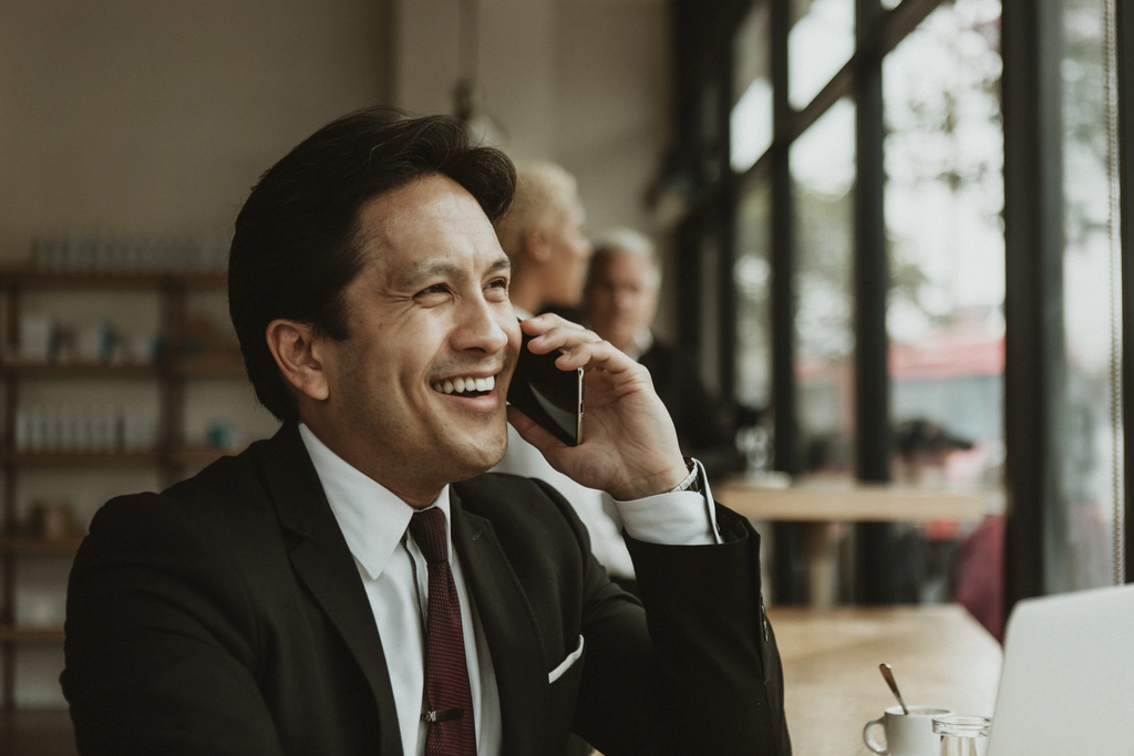 Best IP Phones For Business A man talking on a smart phone using a voip system